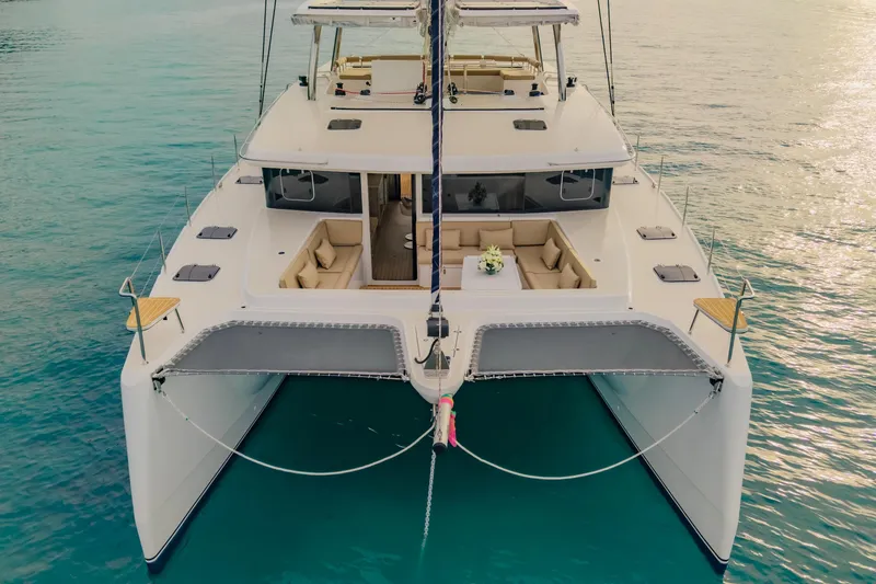 Slide: The Image of 2026 Island Spirit 525E catamaran on tranquil turquoise waters, showcasing luxurious deck seating. - 11