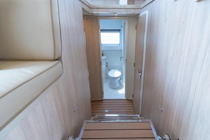 Slide: The Image of Interior of 2026 Island Spirit 525E yacht, featuring a modern bathroom and wooden finishes. - 33