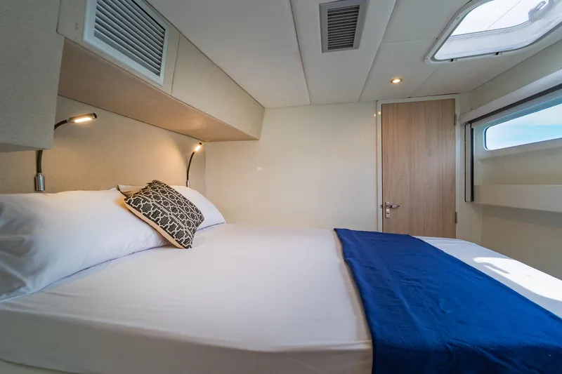 Slide: The Image of Luxurious cabin interior of 2026 Island Spirit 525E yacht with cozy bed and modern lighting. - 35