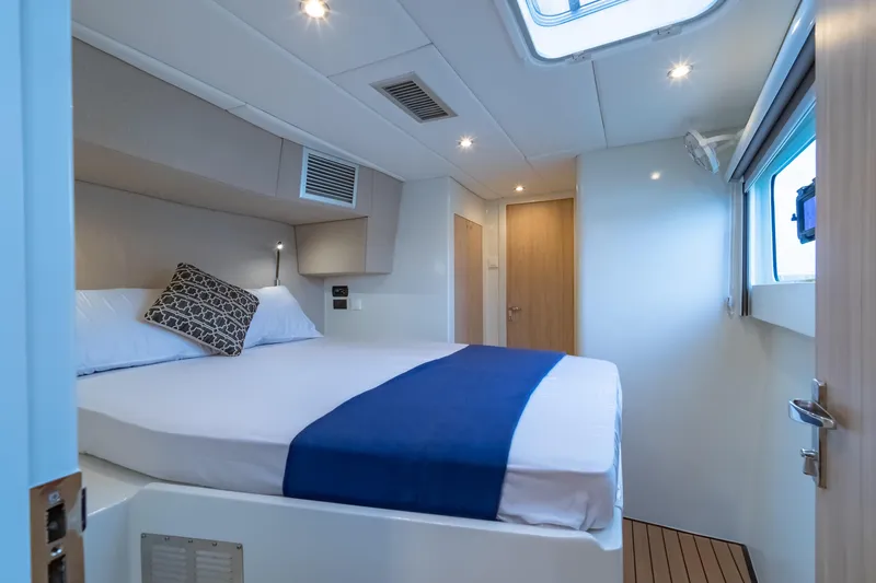 Slide: The Image of Luxurious cabin interior of 2026 Island Spirit 525E yacht with modern bedding and lighting. - 37
