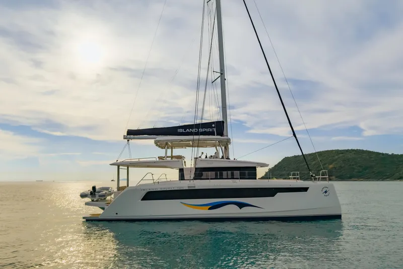 Slide: The Image of 2026 Island Spirit 525E catamaran sailing on calm waters under a bright sky. - 40