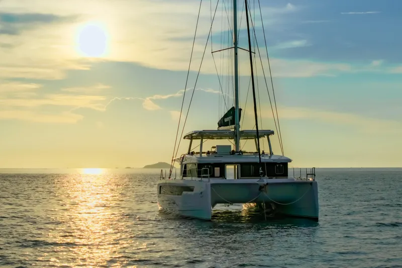 Slide: The Image of Sailing catamaran Island Spirit 525E 2026 at sunset on tranquil ocean waters. - 41