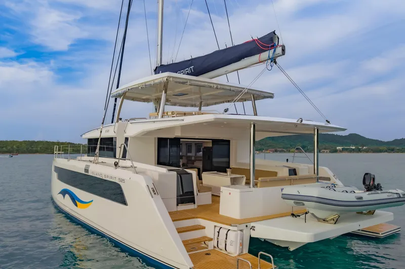 Slide: The Image of Modern Island Spirit 525E catamaran, 2026 model, anchored in serene waters. - 6