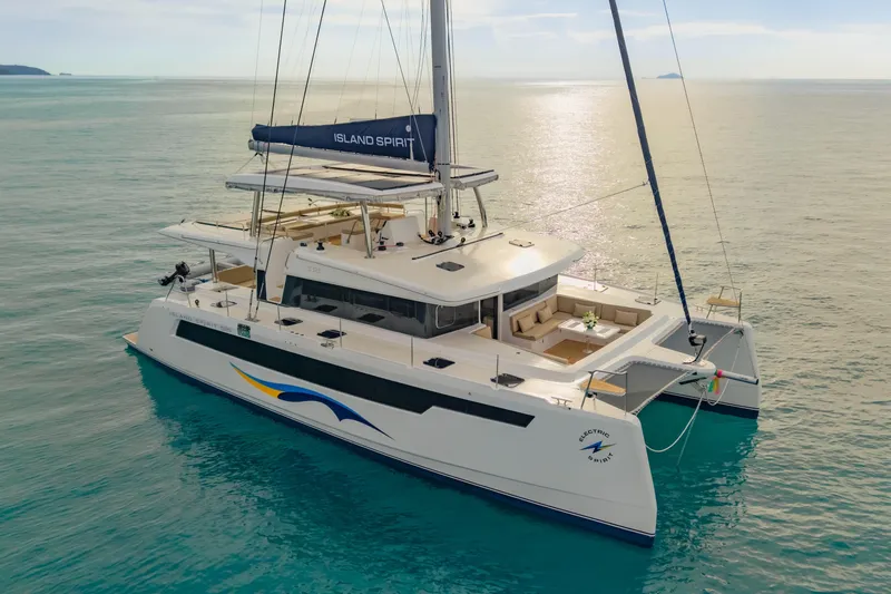 Slide: The Image of 2026 Island Spirit 525E catamaran sailing on calm ocean waters. - 8