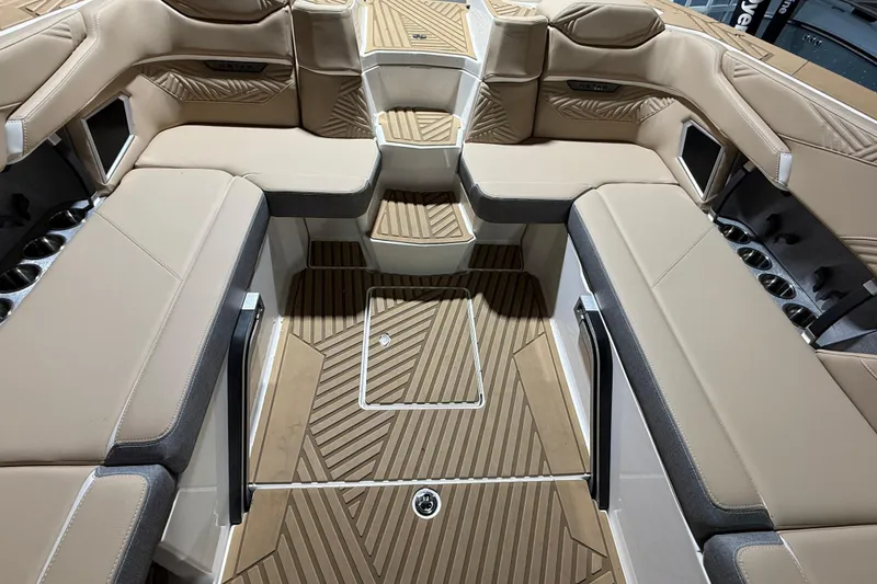 Slide: The Image of 2025 MasterCraft XStar 23 interior with beige seating and wood-patterned flooring. - 5