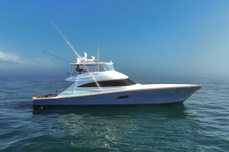 The Image of 2025 Viking 90 Convertible yacht cruising on calm ocean waters. - 1