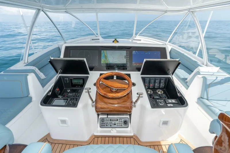 Slide: The Image of 2025 Viking 90 Convertible yacht helm with advanced navigation systems and luxurious seating. - 10