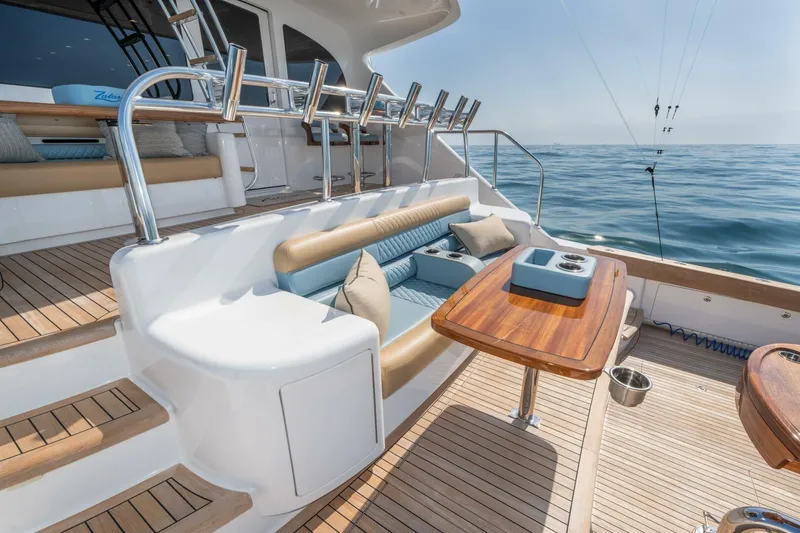 Slide: The Image of Luxurious 2025 Viking 90 Convertible yacht deck with seating and ocean view. - 100