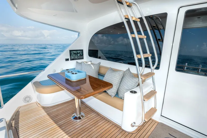 Slide: The Image of Luxurious 2025 Viking 90 Convertible yacht interior with ocean view and elegant seating area. - 101