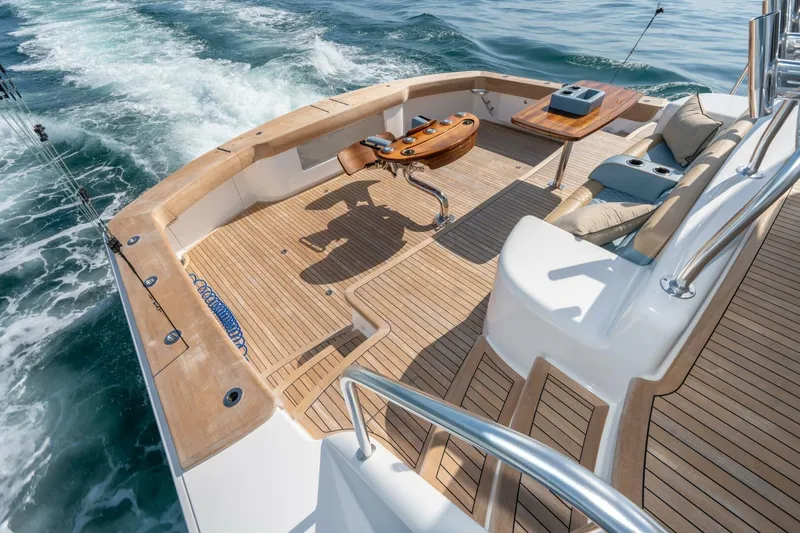 Slide: The Image of Luxurious 2025 Viking 90 Convertible yacht deck with seating and ocean view. - 103