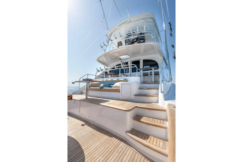 Slide: The Image of 2025 Viking 90 Convertible yacht with elegant deck and seating area. - 104