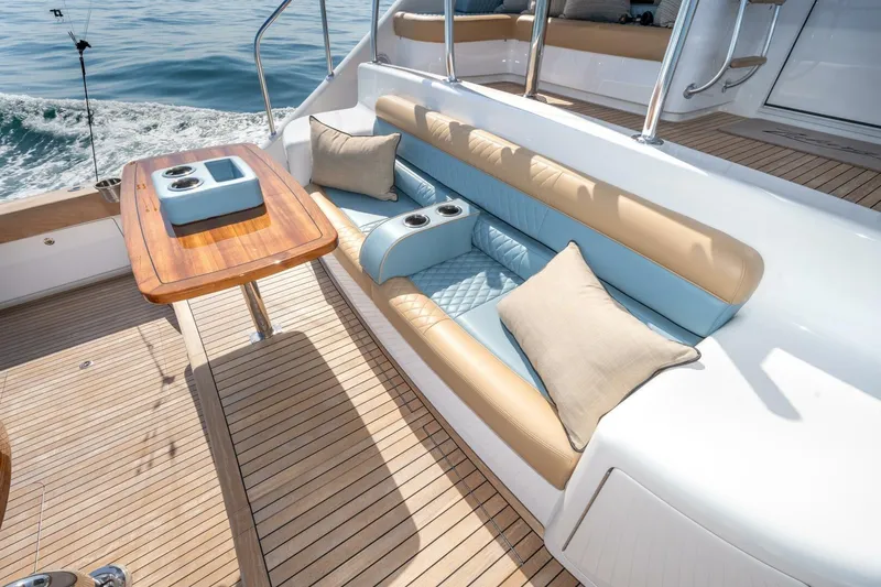 Slide: The Image of Luxurious seating area on 2025 Viking 90 Convertible yacht with elegant wood table. - 105
