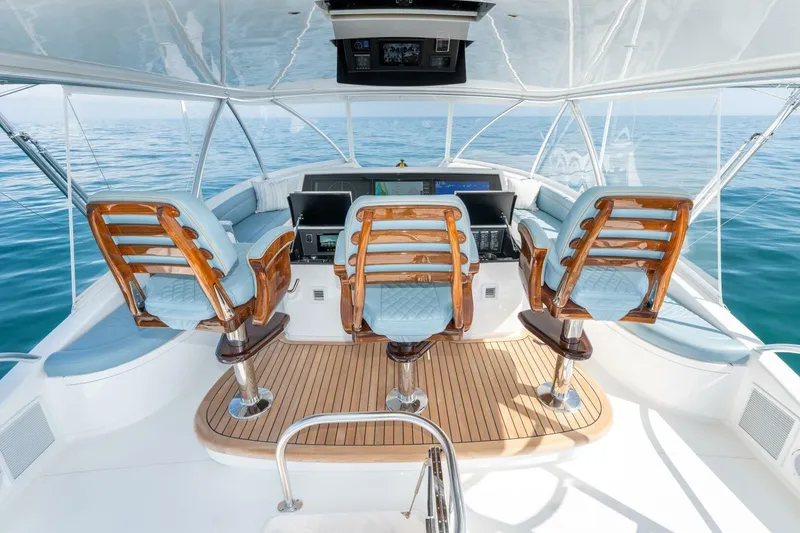 Slide: The Image of 2025 Viking 90 Convertible yacht helm with luxurious seating and ocean view. - 11