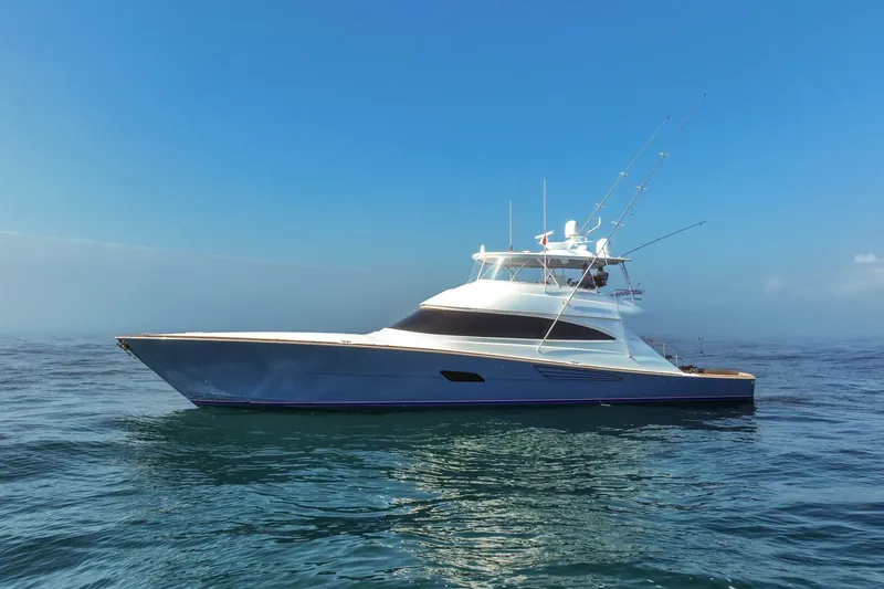 Slide: The Image of 2025 Viking 90 Convertible yacht on open sea under clear blue sky. - 110