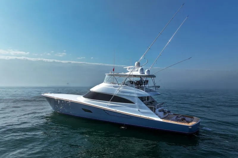 Slide: The Image of 2025 Viking 90 Convertible yacht cruising on open sea under clear blue sky. - 111