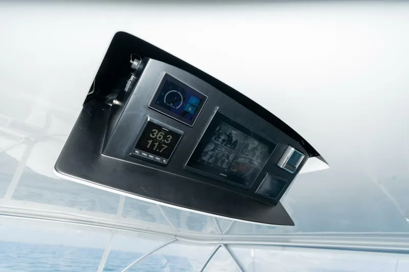 Slide: The Image of 2025 Viking 90 Convertible yacht dashboard with advanced navigation displays. - 14