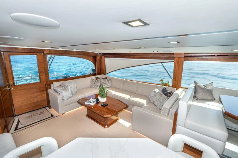 Slide: The Image of Luxurious interior of 2025 Viking 90 Convertible yacht with ocean view and elegant seating. - 18