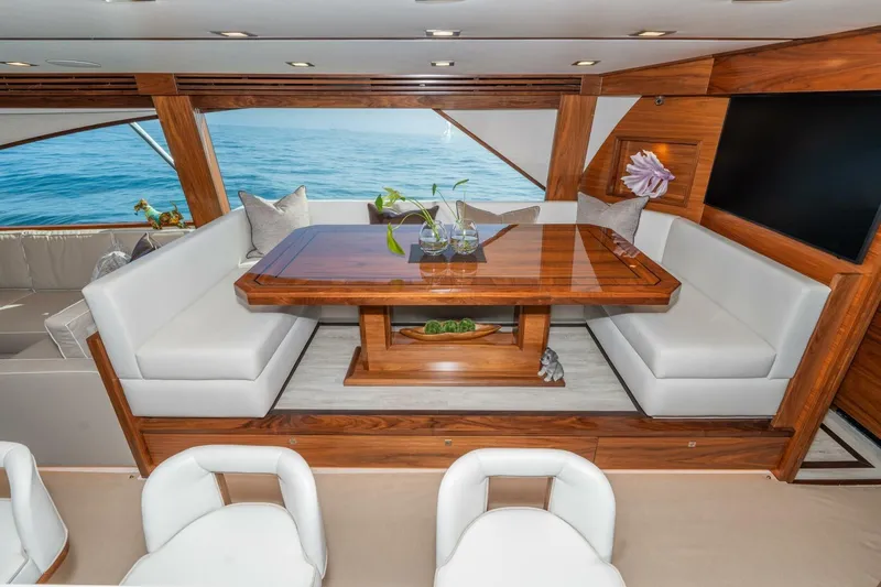 Slide: The Image of Luxurious interior of 2025 Viking 90 Convertible yacht with elegant wood and white seating. - 22