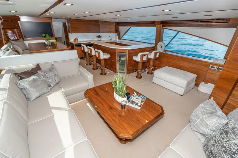 Slide: The Image of Luxurious interior of 2025 Viking 90 Convertible yacht with elegant seating and ocean view. - 24