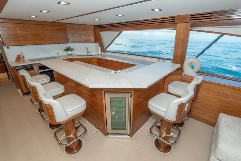 Slide: The Image of Luxurious interior of 2025 Viking 90 Convertible yacht with modern kitchen and ocean view. - 27