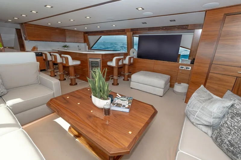 Slide: The Image of Luxurious interior of 2025 Viking 90 Convertible yacht with modern furnishings and ocean view. - 28
