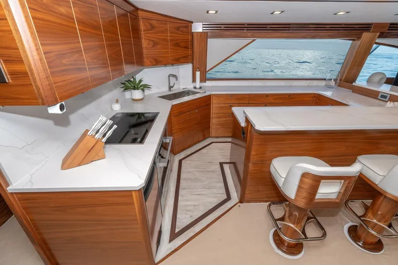 Slide: The Image of Luxurious 2025 Viking 90 Convertible yacht interior with modern kitchen and ocean view. - 29