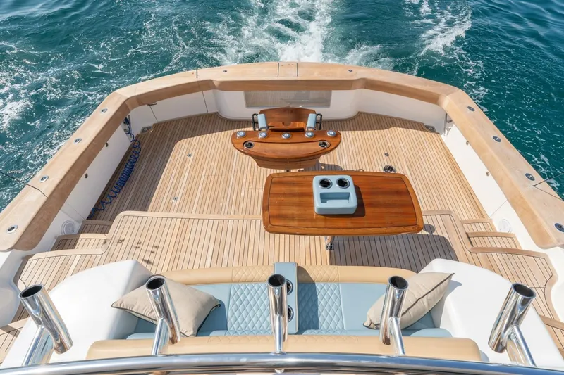 Slide: The Image of Luxurious 2025 Viking 90 Convertible yacht deck with elegant wood finish and ocean view. - 3