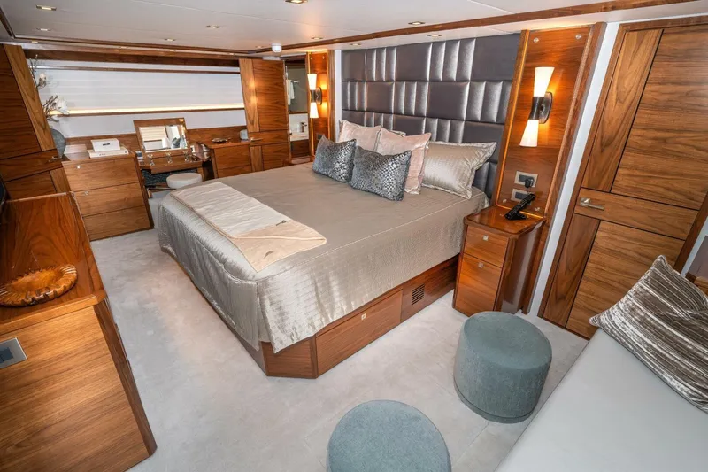 Slide: The Image of Luxurious bedroom interior of 2025 Viking 90 Convertible yacht with elegant wood finishes. - 34