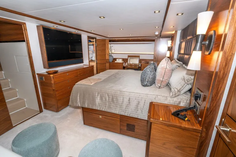 Slide: The Image of Luxurious bedroom interior of 2025 Viking 90 Convertible yacht with elegant wood finishes. - 35