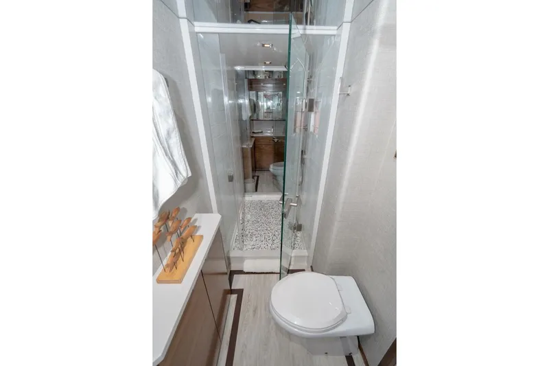 Slide: The Image of Luxurious bathroom in 2025 Viking 90 Convertible yacht with modern fixtures and glass shower. - 39