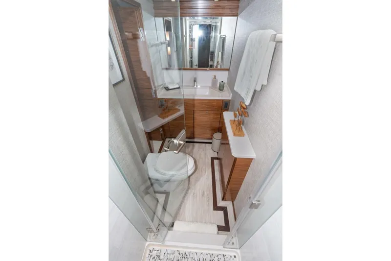 Slide: The Image of Luxurious bathroom in 2025 Viking 90 Convertible yacht with modern fixtures and elegant wood accents. - 40