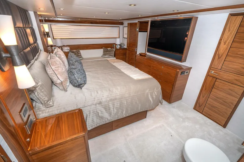 Slide: The Image of Luxurious bedroom interior of 2025 Viking 90 Convertible yacht with elegant wood finishes. - 42