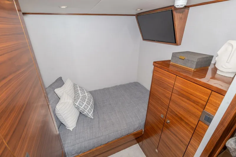 Slide: The Image of Cozy cabin interior of 2025 Viking 90 Convertible yacht with modern wood finish. - 45