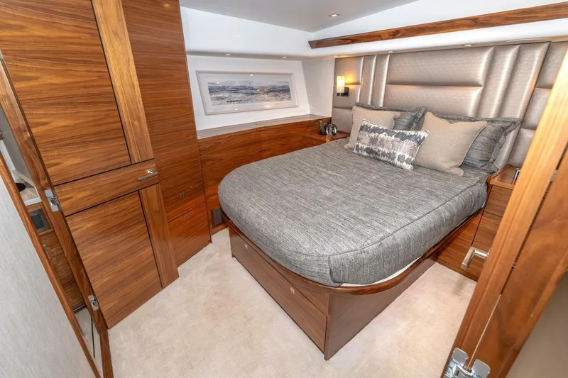 Slide: The Image of Luxurious bedroom interior of 2025 Viking 90 Convertible yacht with elegant wood finishes. - 46