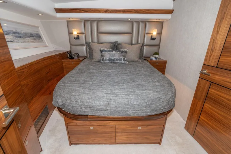 Slide: The Image of Luxurious bedroom interior of 2025 Viking 90 Convertible yacht with elegant wood finishes. - 47
