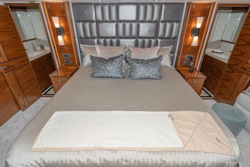 Slide: The Image of Luxurious bedroom interior of 2025 Viking 90 Convertible yacht with elegant decor and plush bedding. - 5