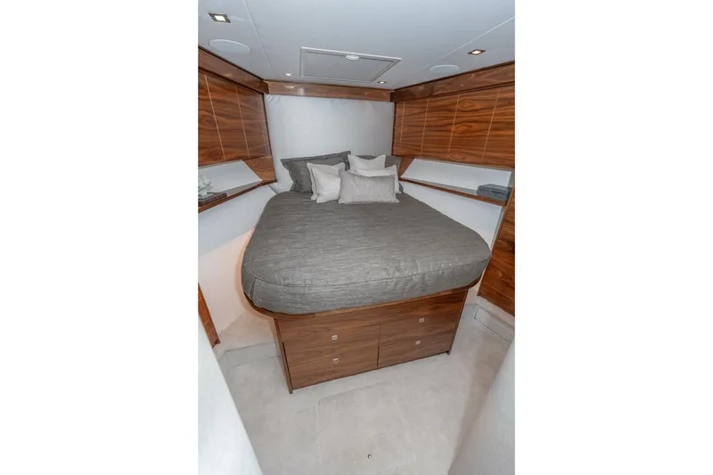 Slide: The Image of Luxurious bedroom in 2025 Viking 90 Convertible yacht with elegant wood paneling. - 52
