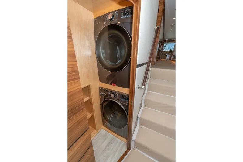 Slide: The Image of Stacked washer and dryer in 2025 Viking 90 Convertible yacht interior. - 56