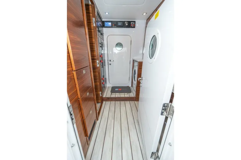 Slide: The Image of Interior of 2025 Viking 90 Convertible yacht with wood paneling and modern design. - 63