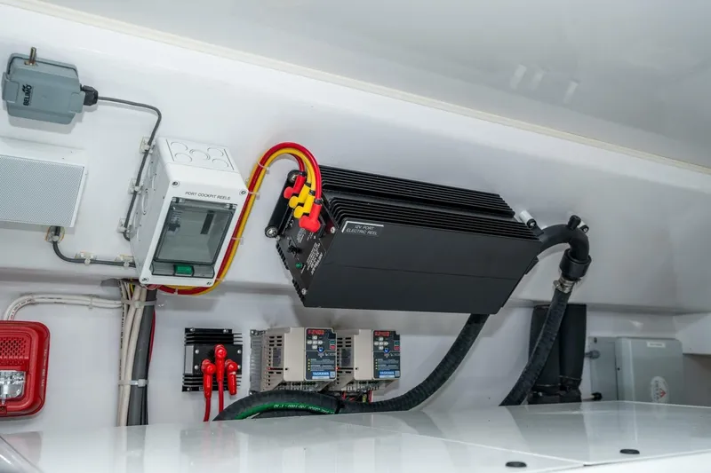 Slide: The Image of Electrical components inside a 2025 Viking 90 Convertible yacht. - 70