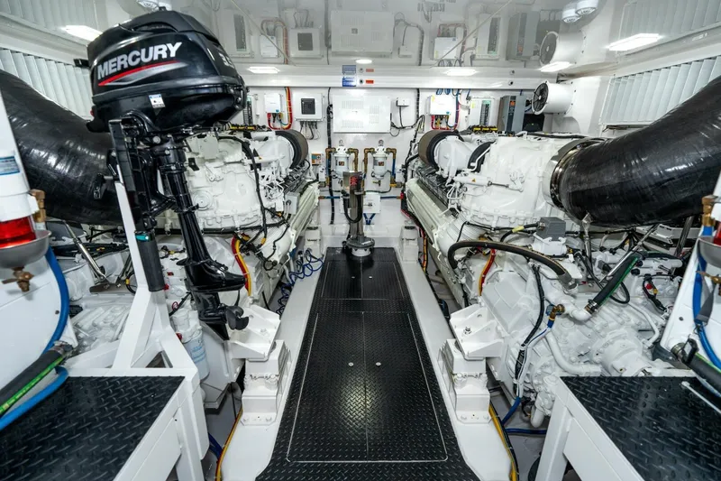 Slide: The Image of Engine room of 2025 Viking 90 Convertible yacht, featuring advanced machinery and Mercury outboard motor. - 75