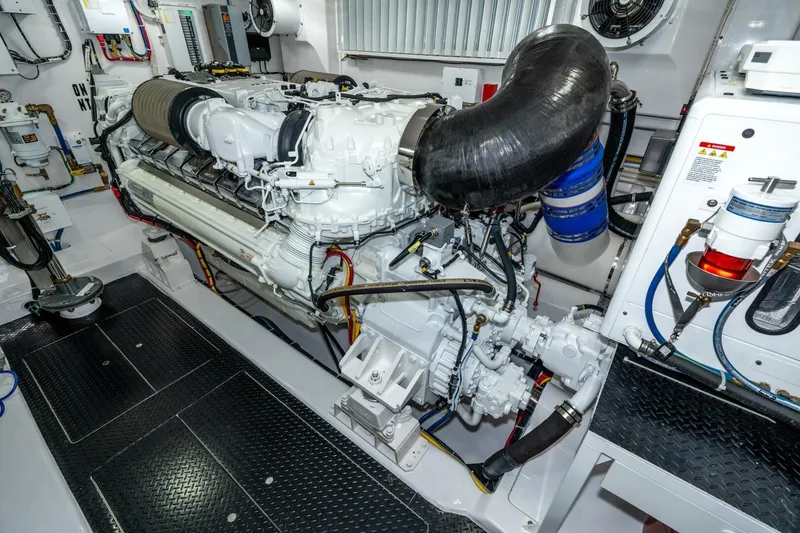 Slide: The Image of Engine room of 2025 Viking 90 Convertible yacht, showcasing advanced machinery and components. - 77