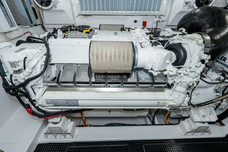 Slide: The Image of Engine room of 2025 Viking 90 Convertible yacht, showcasing advanced machinery and components. - 78