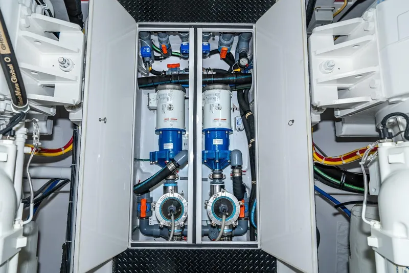 Slide: The Image of Engine room of 2025 Viking 90 Convertible yacht, showcasing advanced machinery and piping. - 87