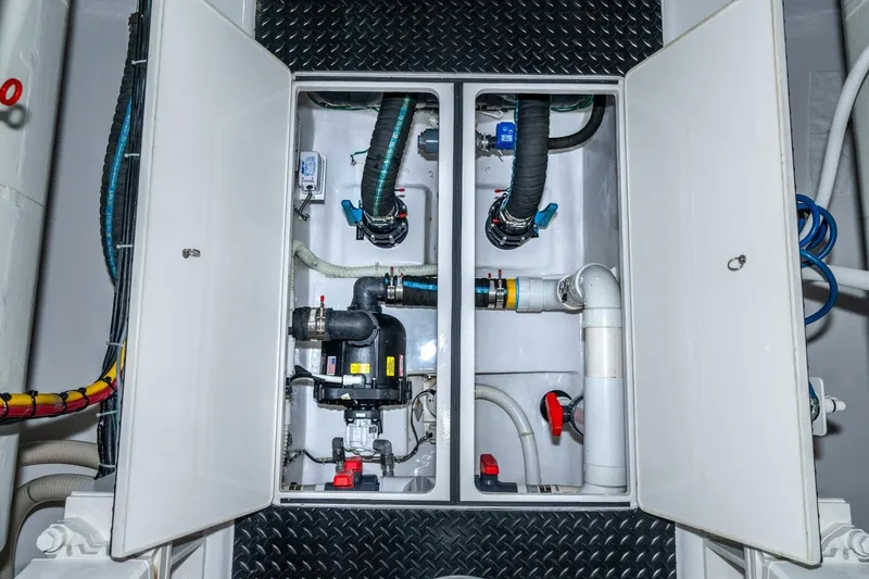Slide: The Image of Engine room of 2025 Viking 90 Convertible yacht with visible plumbing and machinery. - 89