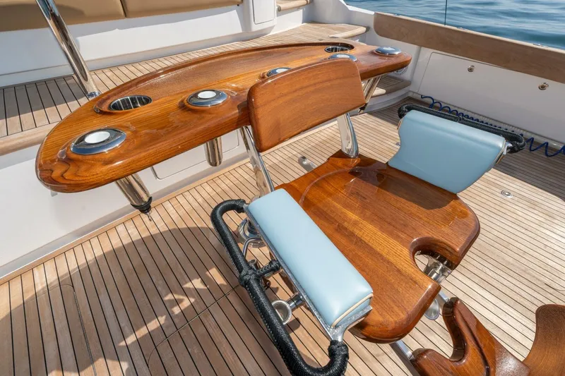 Slide: The Image of Luxury fishing chair on 2025 Viking 90 Convertible yacht, featuring teak deck and rod holders. - 96