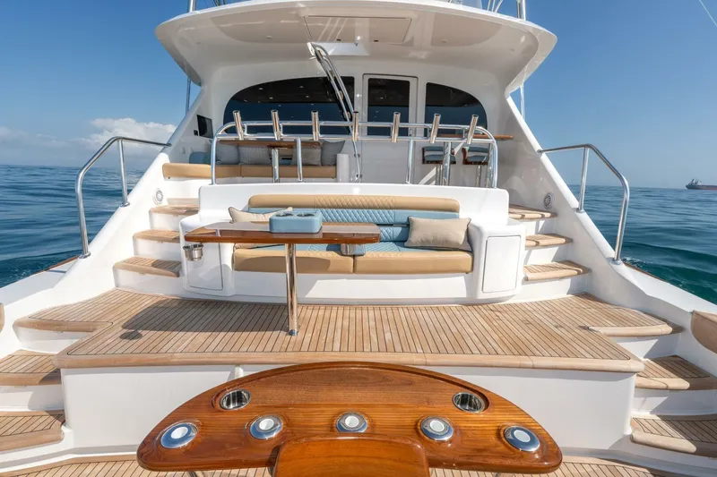 Slide: The Image of Luxurious 2025 Viking 90 Convertible yacht with elegant teak deck and plush seating. - 98