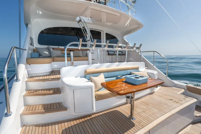 Slide: The Image of Luxurious 2025 Viking 90 Convertible yacht deck with elegant seating and ocean view. - 99