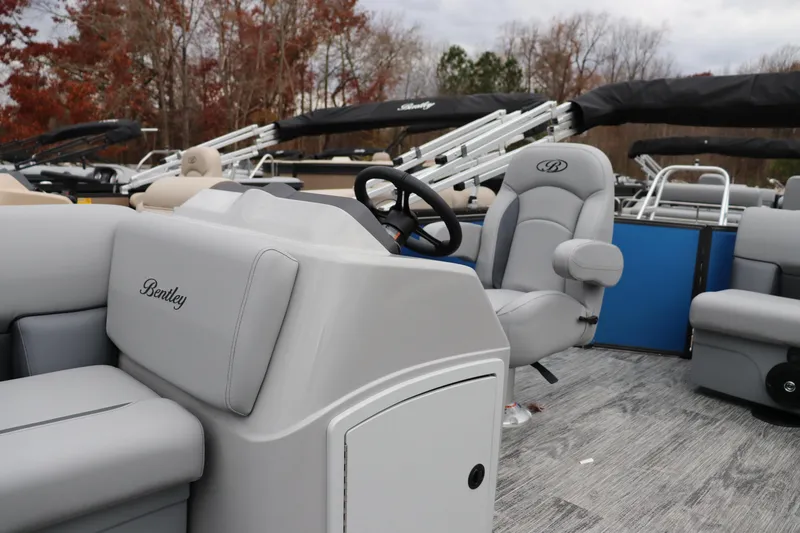 Slide: The Image of 2026 Bentley Pontoons 160 Cruise interior with steering wheel and seating, showcasing luxury design. - 4