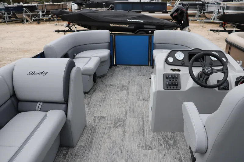 Slide: The Image of 2026 Bentley Pontoons 160 Cruise interior with gray seating and modern dashboard. - 8